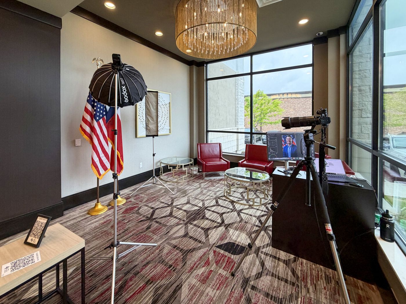 Full studio setup — light, backdrop, and tethered camera — built in a conference room